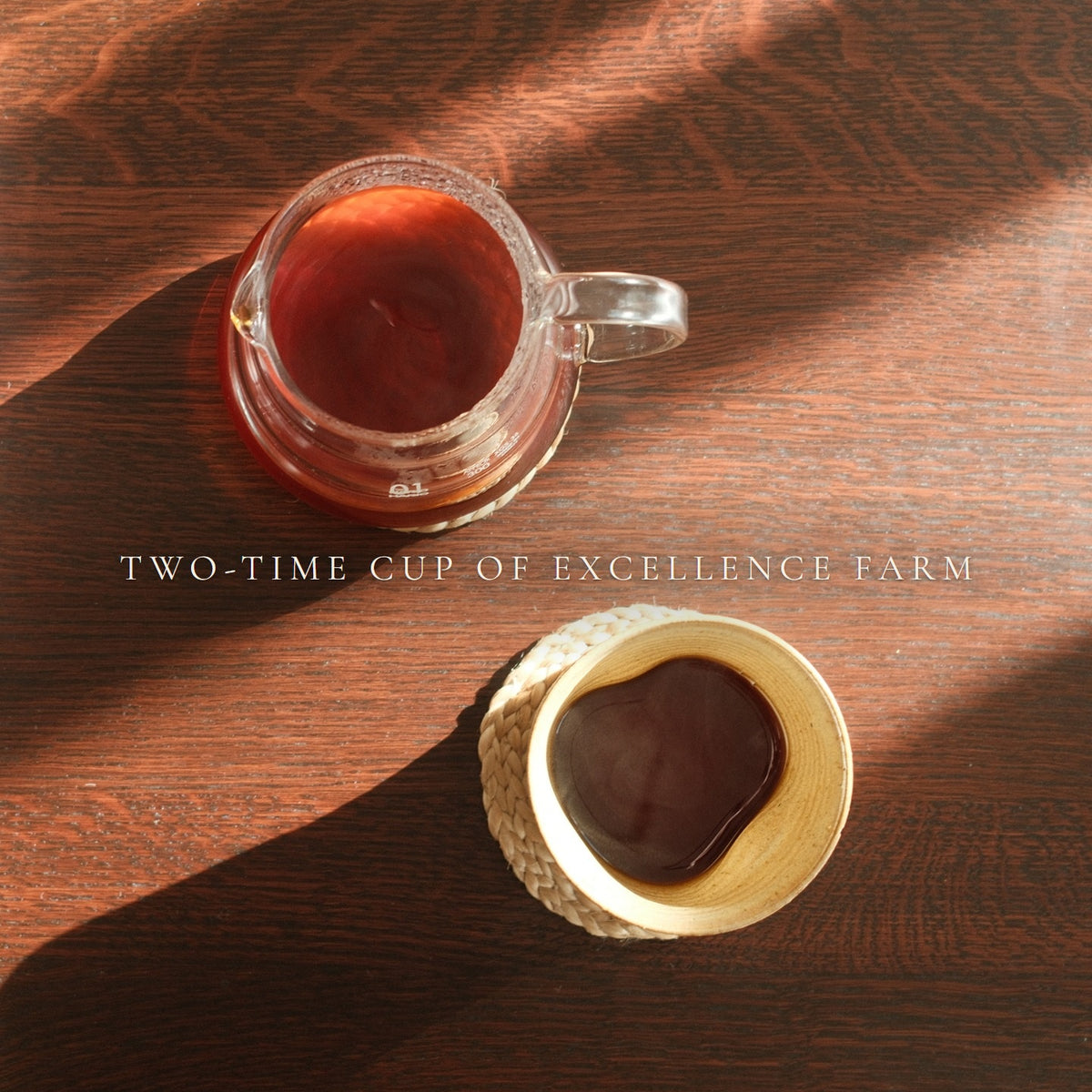Filter coffee from a two-time Cup of Excellence farm, server and cup on a wooden table